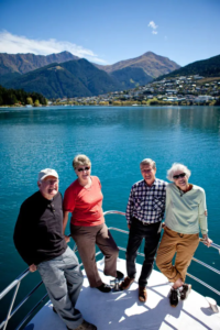 Happy passengers cruising on Lake Wakatipu with MIllion Dollar Cruise
