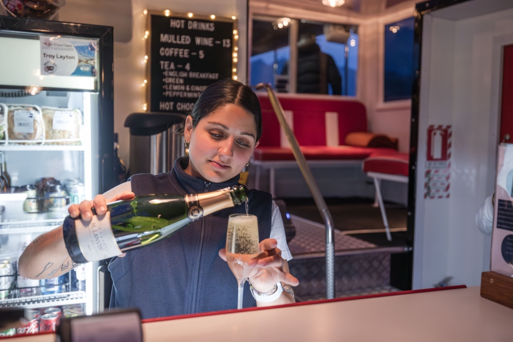 BrookedV_MDC_May25-10-min Woman pouring champagne into a flute on a cruise.
